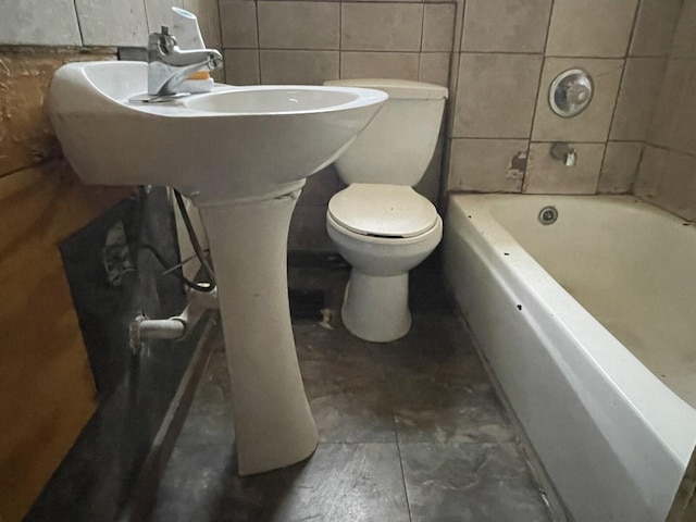 full bath with toilet, tile walls, and a bath