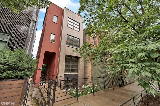 view of building exterior with fence