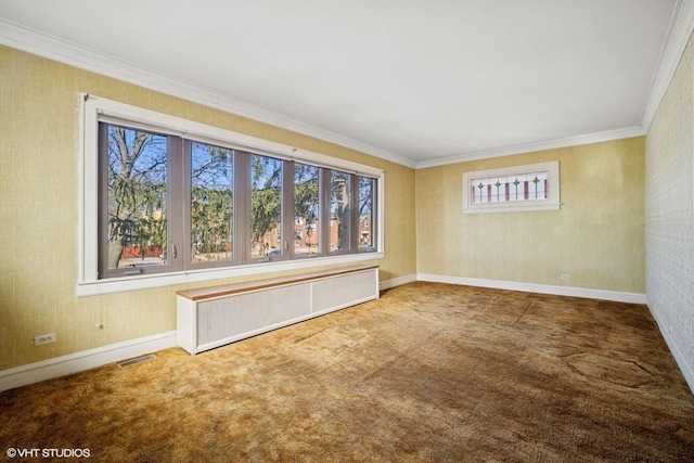 carpeted empty room featuring a wealth of natural light, radiator, visible vents, and wallpapered walls