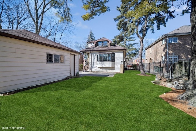 back of property featuring a yard and fence