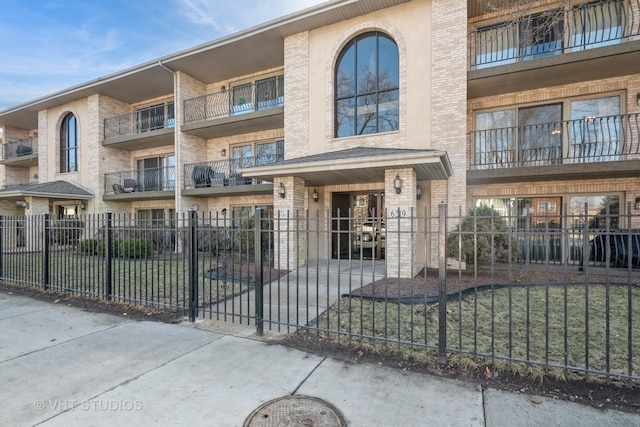 view of building exterior featuring a fenced front yard