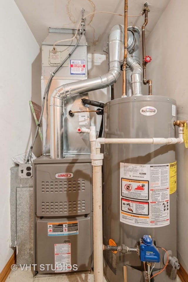 utility room featuring gas water heater and heating unit