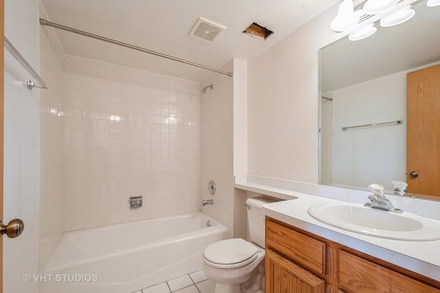 bathroom with toilet, vanity, visible vents, tile patterned floors, and washtub / shower combination