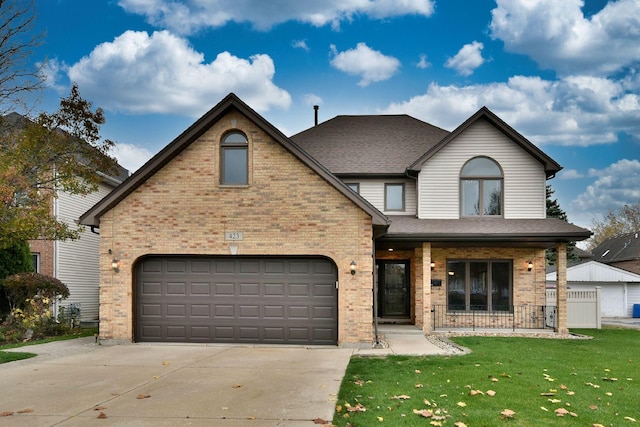 traditional-style house with brick siding, a shingled roof, concrete driveway, a front yard, and a garage