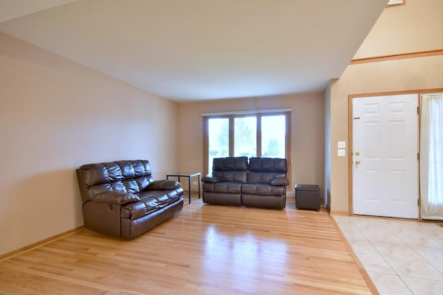 living area with light wood-style flooring and baseboards