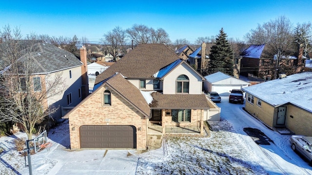 view of front of house featuring brick siding, roof with shingles, a porch, a garage, and a residential view