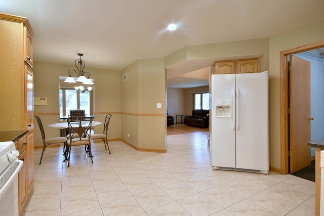 dining space featuring a chandelier, light tile patterned flooring, visible vents, and baseboards