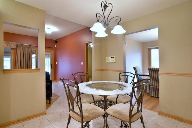 dining area with light tile patterned floors and baseboards