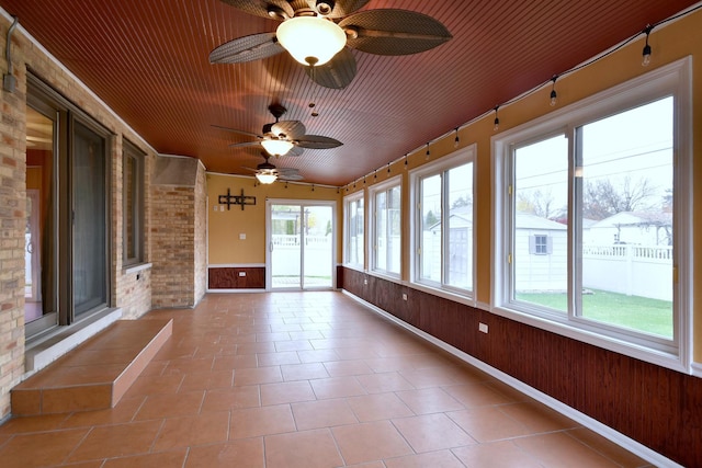 unfurnished sunroom with wood ceiling