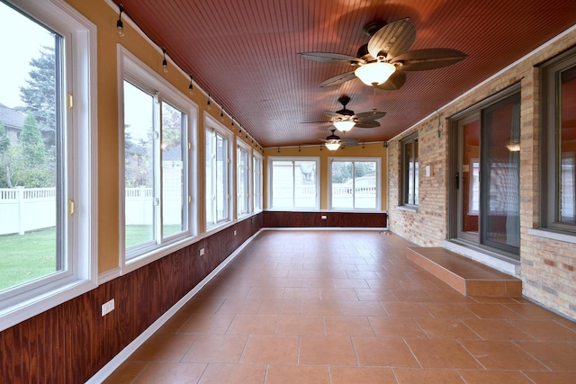 unfurnished sunroom featuring wood ceiling