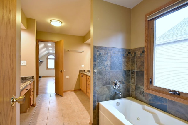 bathroom with baseboards, vanity, a whirlpool tub, and tile patterned floors