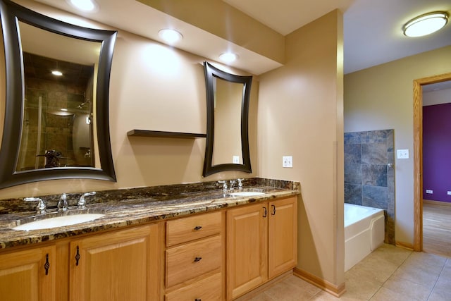 bathroom with tile patterned floors, a sink, a shower stall, and double vanity