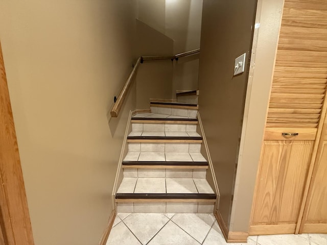 stairs with tile patterned floors