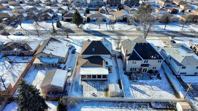 snowy aerial view with a residential view