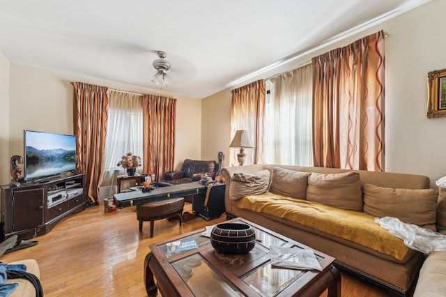 living room with a healthy amount of sunlight, light wood-style floors, and a ceiling fan