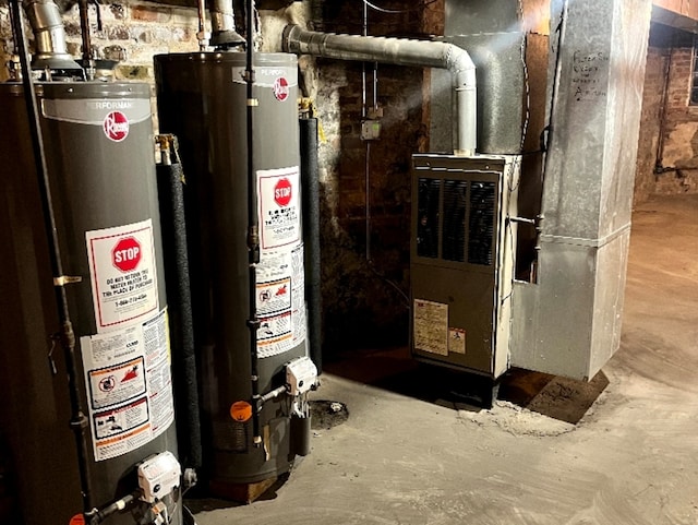 utility room featuring gas water heater and heating unit