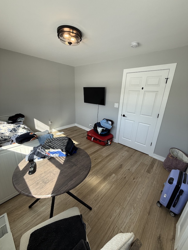 interior space with baseboards and wood finished floors