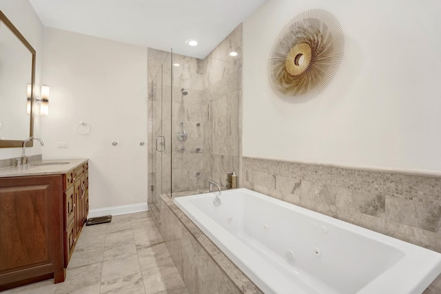 full bathroom with baseboards, a shower stall, a whirlpool tub, and vanity