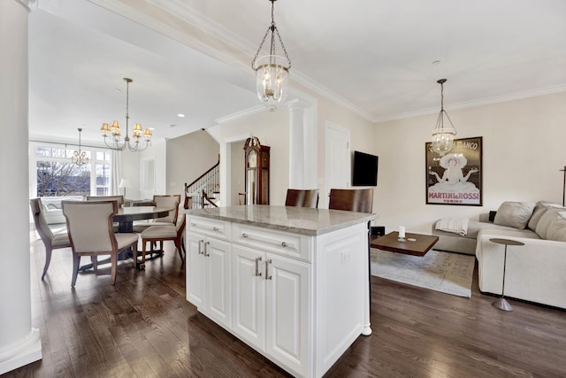 kitchen featuring open floor plan, hanging light fixtures, dark wood finished floors, and an inviting chandelier