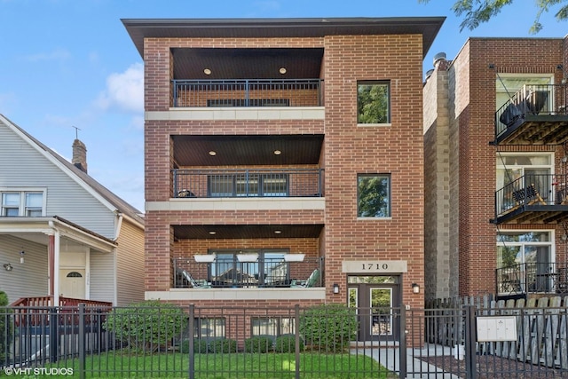 view of building exterior with a fenced front yard