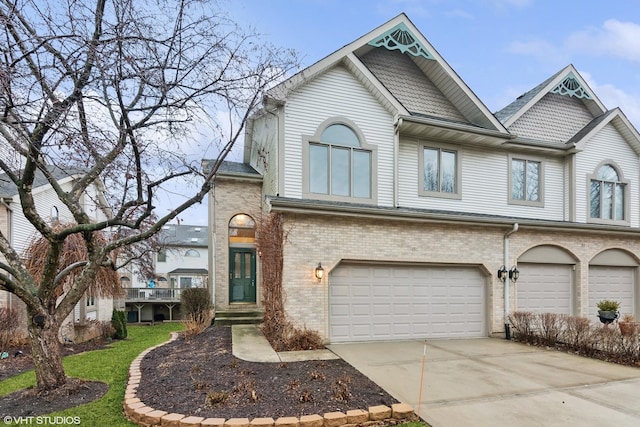 view of front facade featuring driveway, a garage, and brick siding