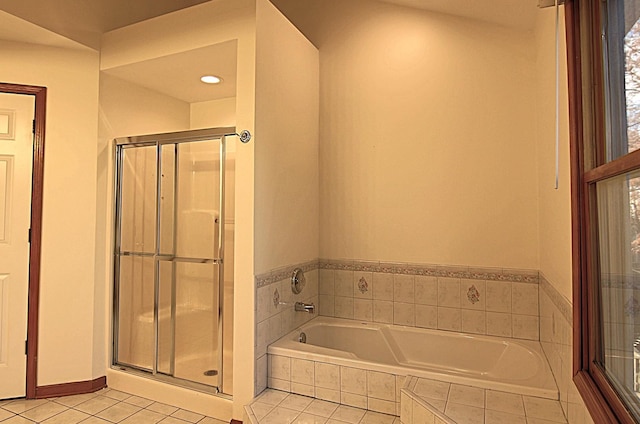 full bathroom with a stall shower, a garden tub, baseboards, and tile patterned floors