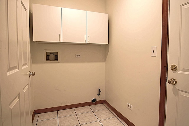 laundry room with hookup for a washing machine, cabinet space, baseboards, and light tile patterned floors