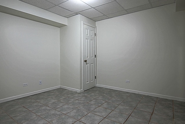 unfurnished room featuring baseboards and a drop ceiling