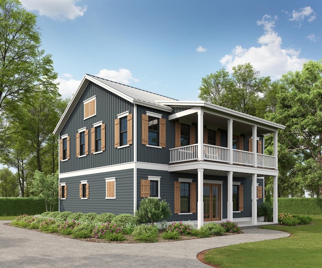 view of front of property featuring metal roof, a standing seam roof, and a balcony