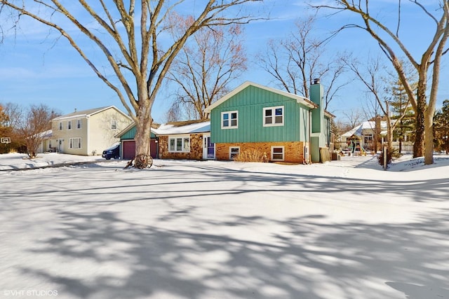 view of front of house featuring a chimney, board and batten siding, and brick siding