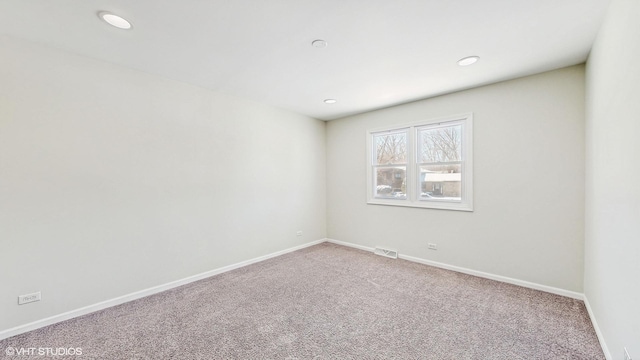 carpeted empty room with recessed lighting, visible vents, and baseboards