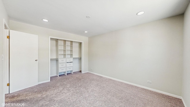 unfurnished bedroom featuring a closet, baseboards, carpet flooring, and recessed lighting