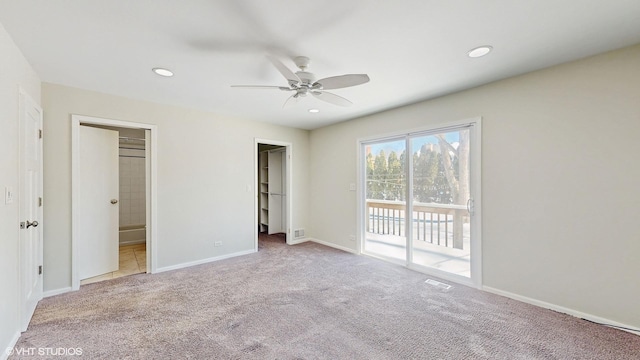 unfurnished bedroom featuring recessed lighting, carpet floors, baseboards, access to exterior, and a spacious closet