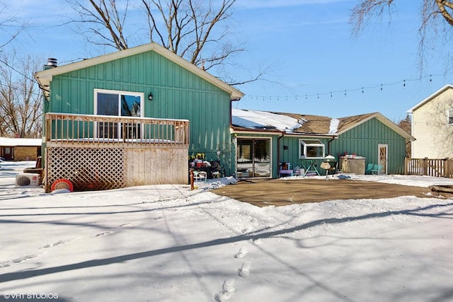 view of front of house featuring a deck, solar panels, and board and batten siding