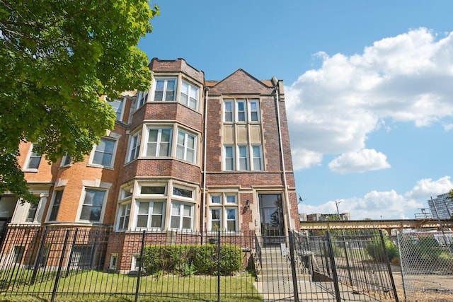 view of building exterior with a fenced front yard