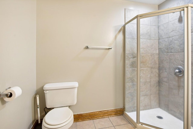 full bathroom with toilet, a shower stall, baseboards, and tile patterned floors