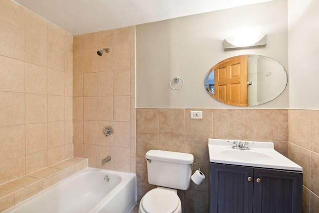 full bathroom featuring toilet, vanity, tile walls, and shower / bathtub combination