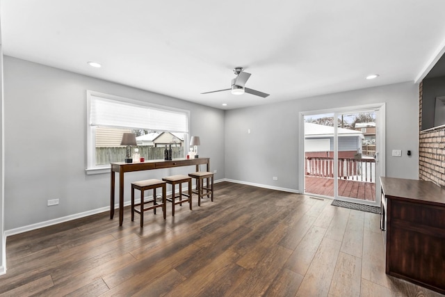 dining space featuring a wealth of natural light, baseboards, and hardwood / wood-style floors