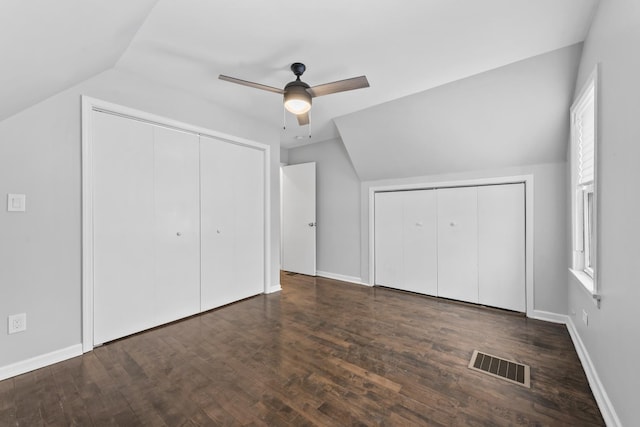 unfurnished bedroom with wood finished floors, a ceiling fan, visible vents, vaulted ceiling, and baseboards