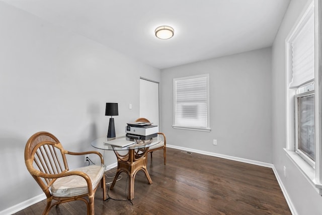 sitting room featuring visible vents, baseboards, and wood finished floors