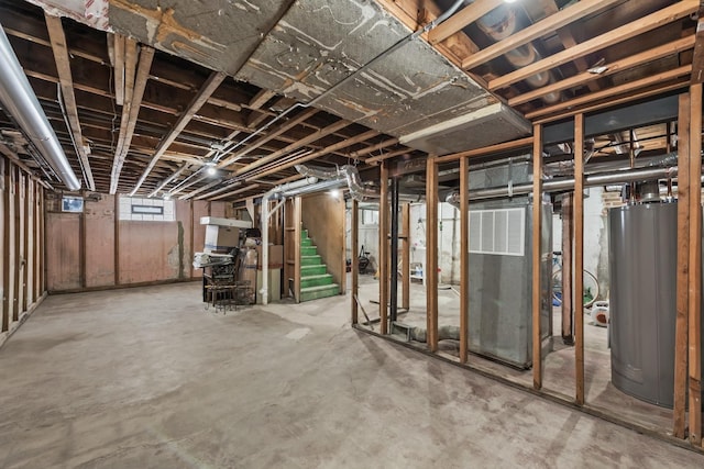 basement with gas water heater and stairway