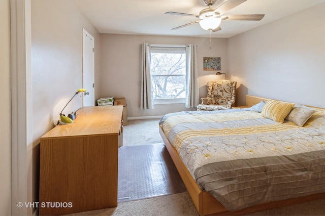 carpeted bedroom with ceiling fan and baseboards