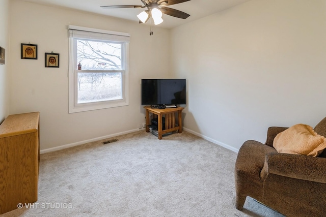 sitting room featuring carpet, visible vents, ceiling fan, and baseboards