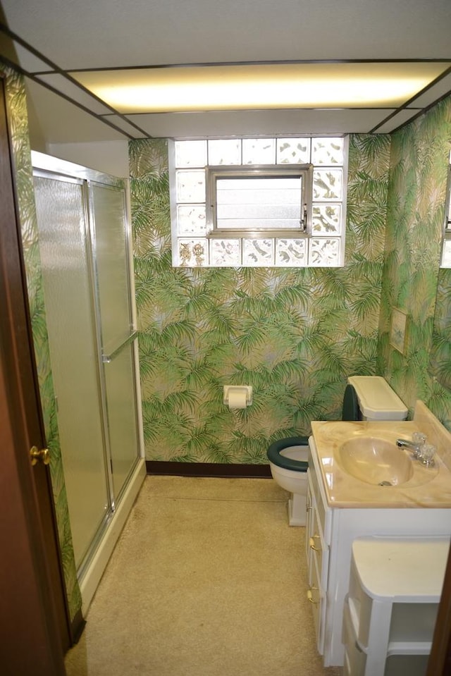 full bathroom featuring toilet, a stall shower, vanity, and wallpapered walls