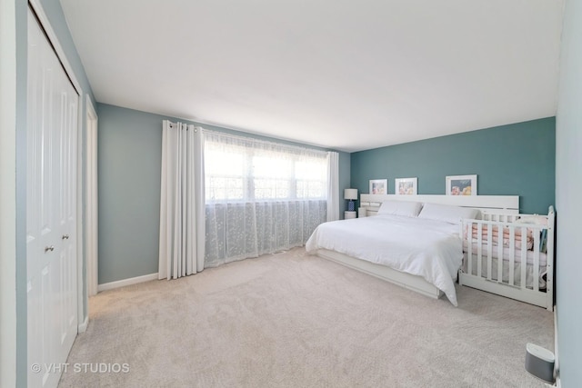 bedroom featuring a closet, carpet floors, and baseboards