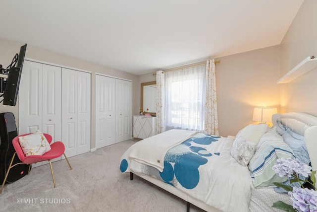 carpeted bedroom with two closets