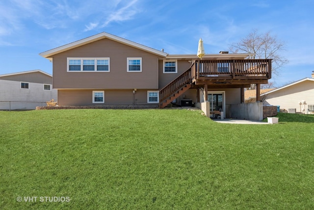 rear view of property featuring a wooden deck, a lawn, cooling unit, and stairs