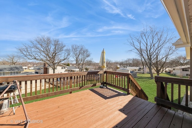 wooden deck featuring a residential view and a lawn