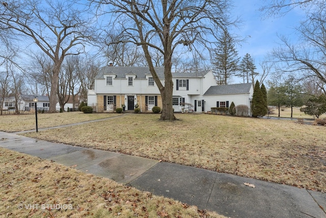 colonial-style house with a front yard