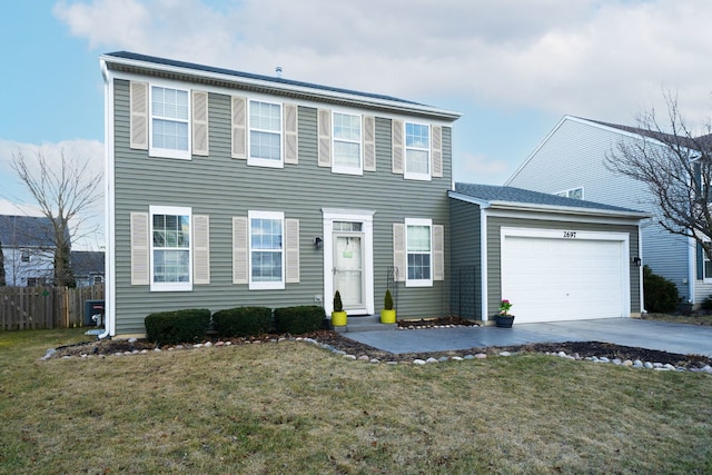 colonial inspired home with an attached garage, driveway, fence, and a front lawn